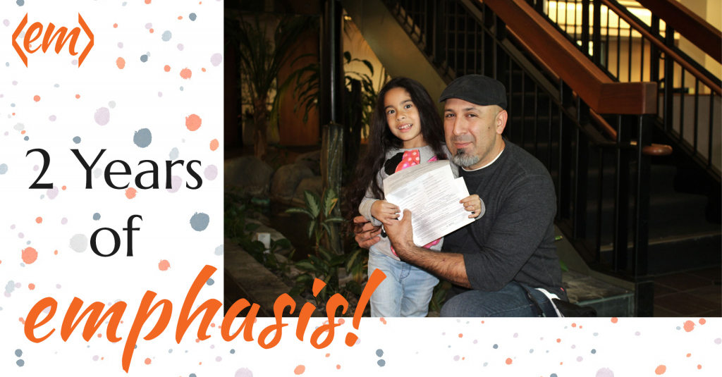 Jason Orellana with daughter holding business documents