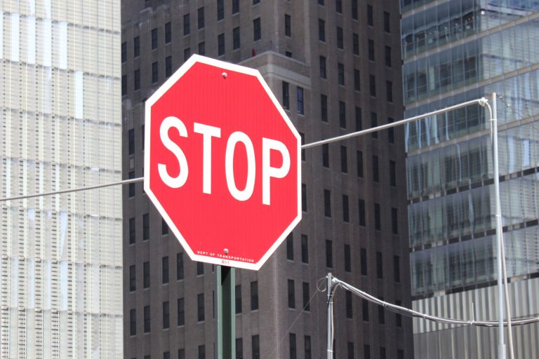 red stop sign in front of office buildings